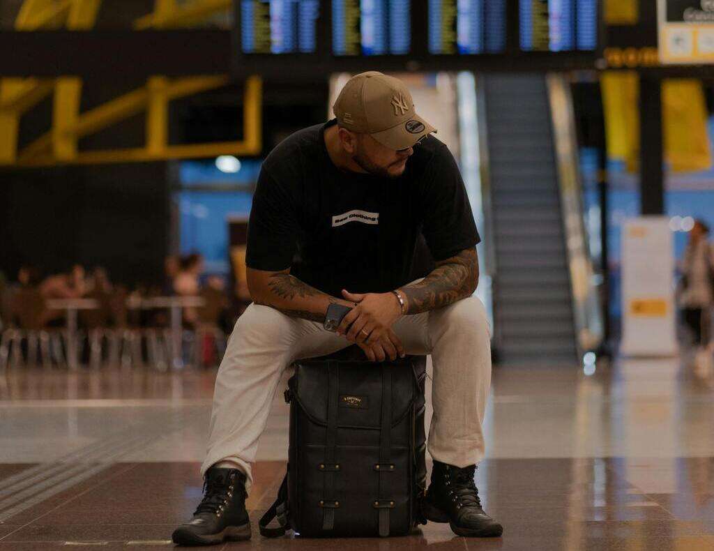 A male passenger sits in an airport departure terminal.