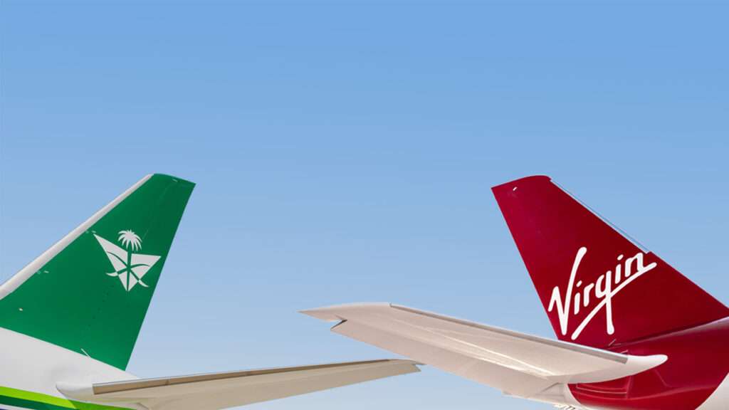 Tailplanes of Saudia and Virgin Atlantic planes together.