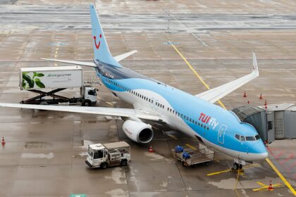 A TUI fly Boeing 737-800 parked at the terminal.